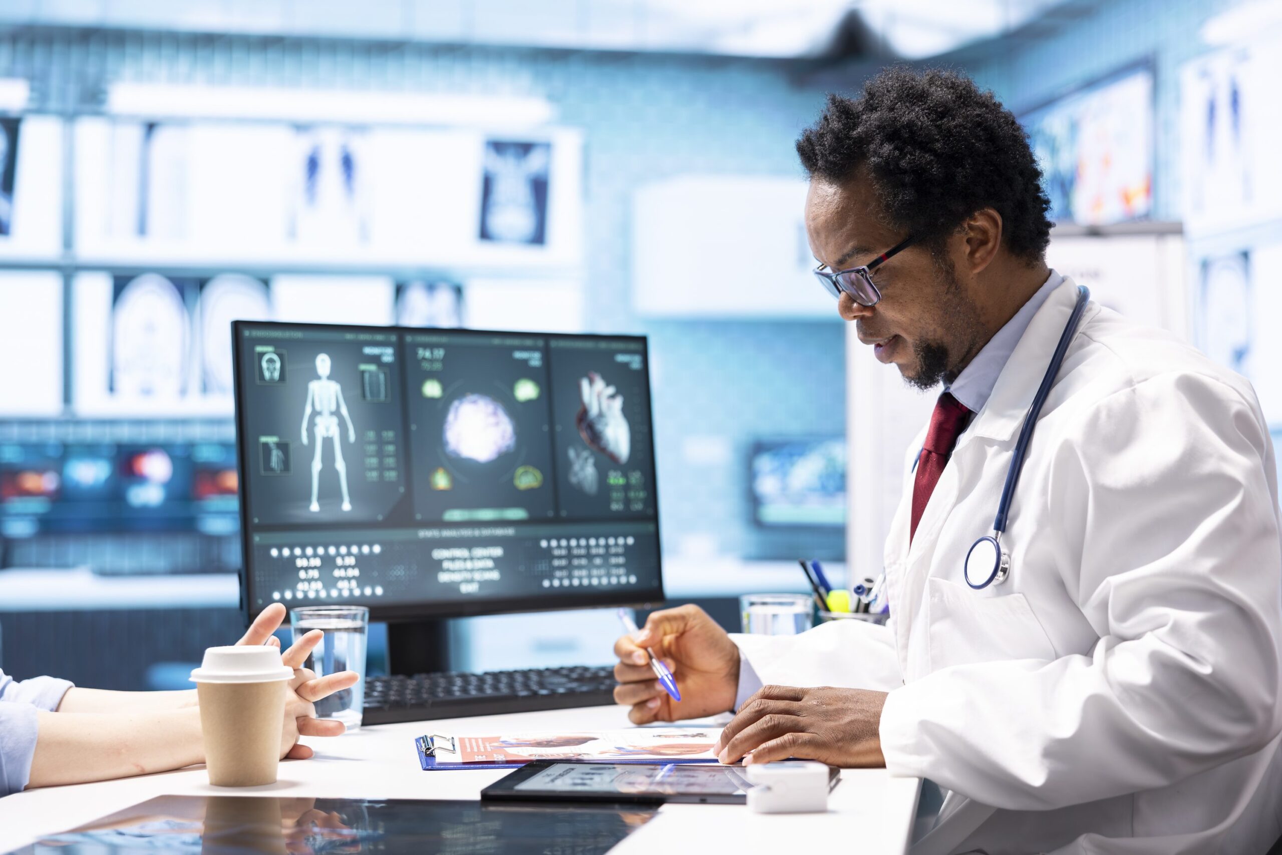 Clinician reviewing medical imaging on computer monitors